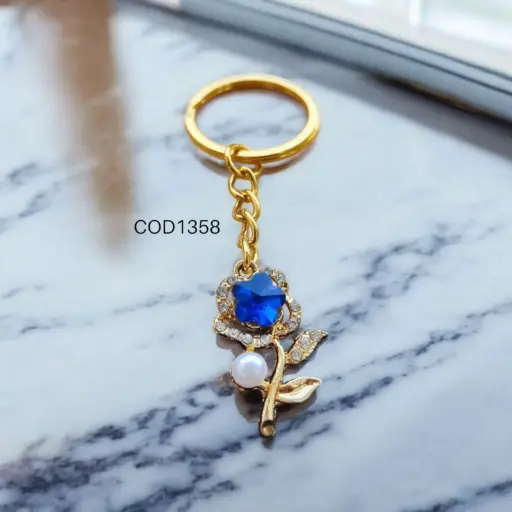 Llavero de rosa con piedra azul